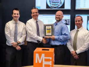 Security Solutions salespeople accepting an award from Chris Throckmorton of exacvision