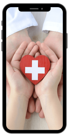 Iphone medical healthcare image of doctor and children's hands holding a red heart with a white cross for the MCC Healthcare technology solutions page.