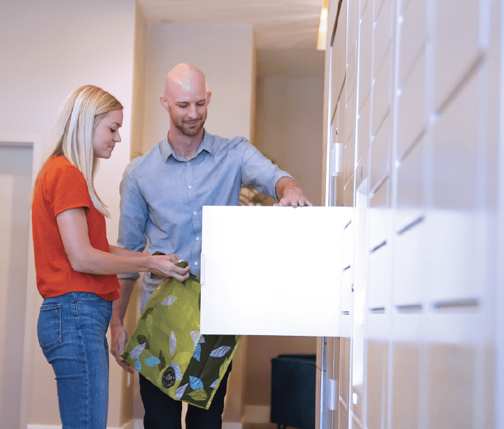 Two people using the quadient parcel pending locker system