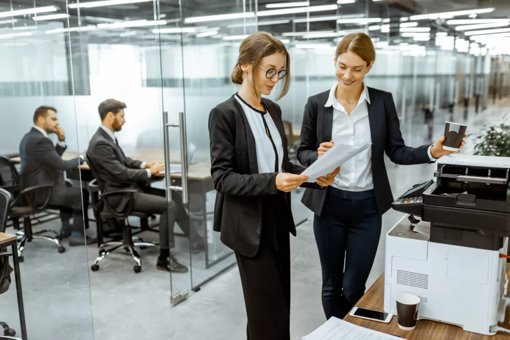 Business people near the copier in the hallway